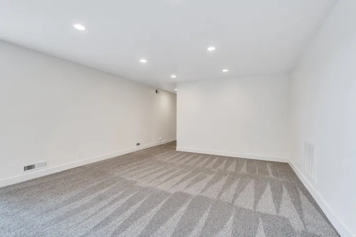 Spare room featuring recessed lighting and light colored carpet