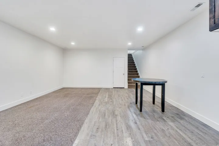 Finished basement featuring recessed lighting and light wood finished floors