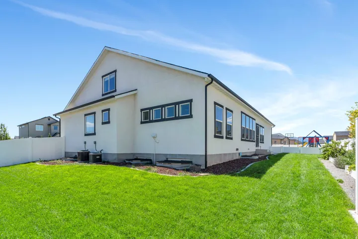 Rear view of house featuring stucco siding