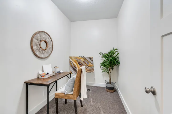Office area with dark carpet and baseboards