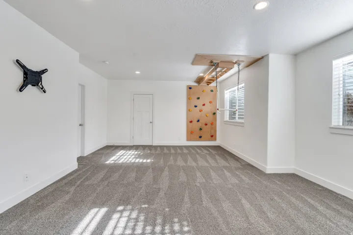Carpeted spare room with recessed lighting and a textured ceiling
