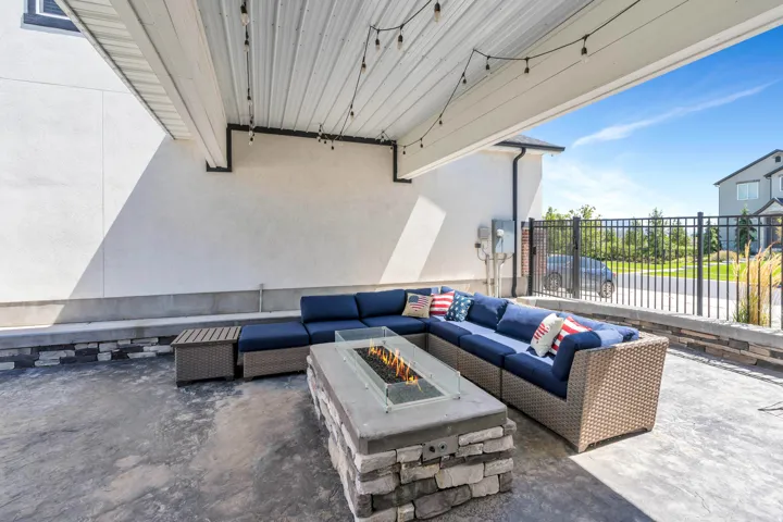 View of patio with an outdoor living space with a fire pit