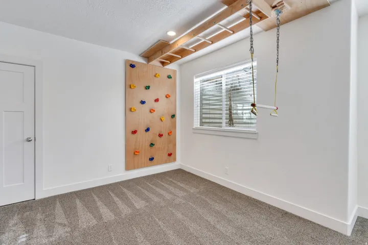 Empty room featuring carpet, recessed lighting, and a textured ceiling