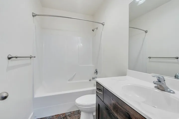 Bathroom featuring vanity and shower / bathtub combination