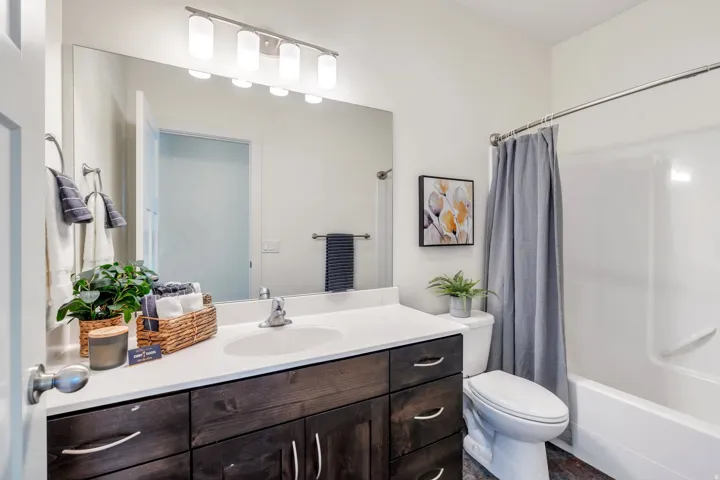 Bathroom featuring shower / bathtub combination with curtain and vanity