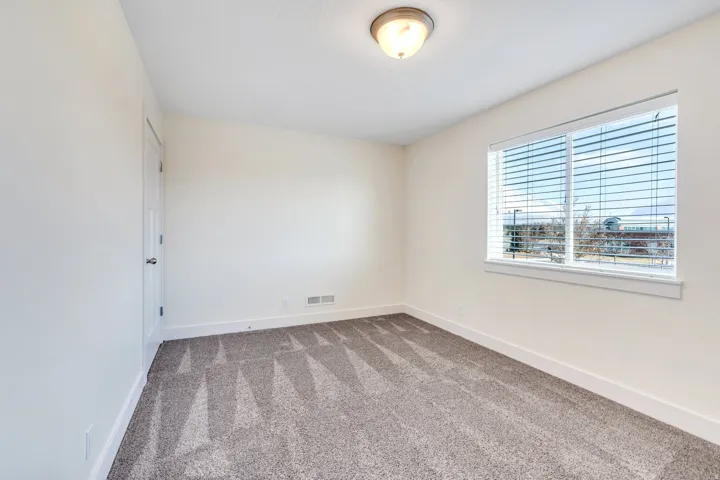 Unfurnished room featuring baseboards and carpet