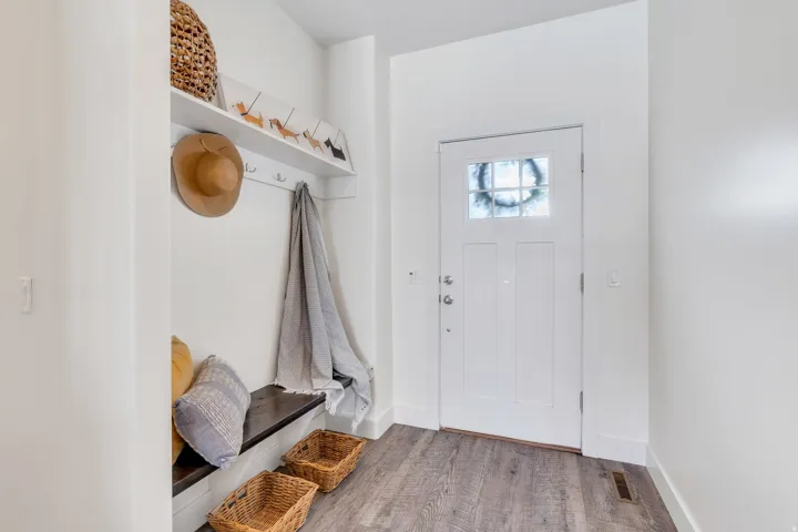 Mudroom with wood finished floors and baseboards