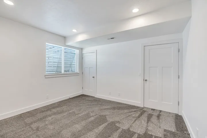 Unfurnished bedroom with carpet floors, recessed lighting, and a closet