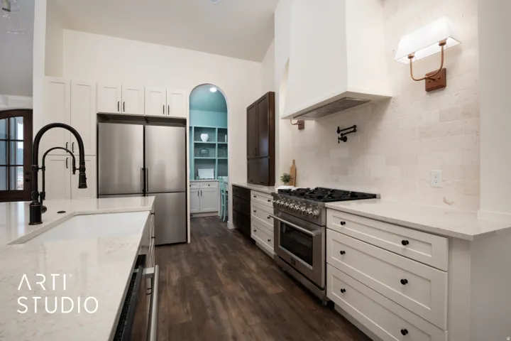 Kitchen featuring light stone countertops, stainless steel appliances, white cabinets, dark wood-type flooring, and backsplash