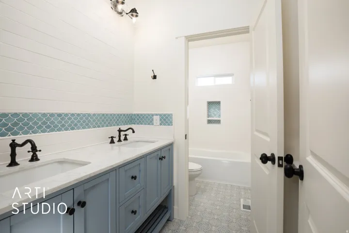 Bathroom featuring double vanity and toilet