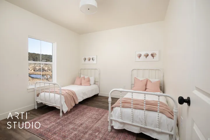 Bedroom with dark wood-type flooring and baseboards