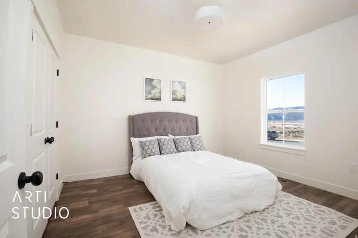 Bedroom featuring a closet and dark wood-style floors