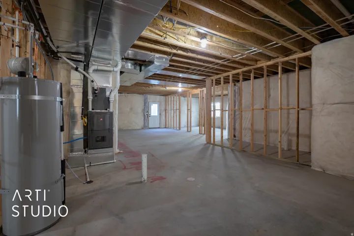 Below grade area featuring water heater and heating unit