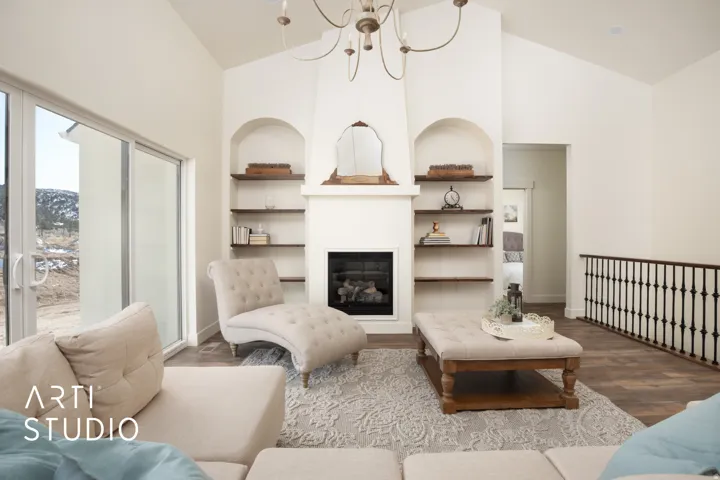 Living area with built in shelves, a chandelier, a fireplace, wood finished floors, and vaulted ceiling