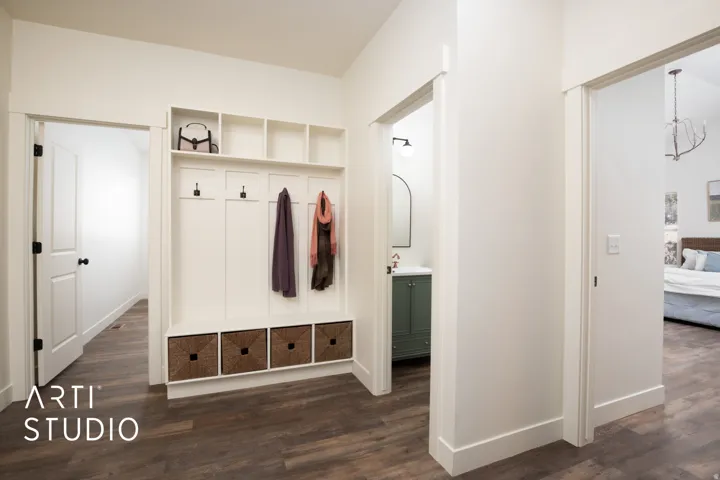 Mudroom featuring dark wood-style floors and baseboards