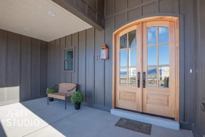Entrance to property with board and batten siding, french doors, and a mountain view