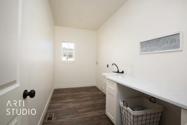 Laundry room featuring hookup for a washing machine, dark wood-type flooring, cabinet space, and electric dryer hookup