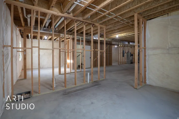 Unfinished basement with gas water heater and a central vacuum unit