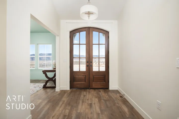 Foyer featuring french doors and dark wood-type flooring