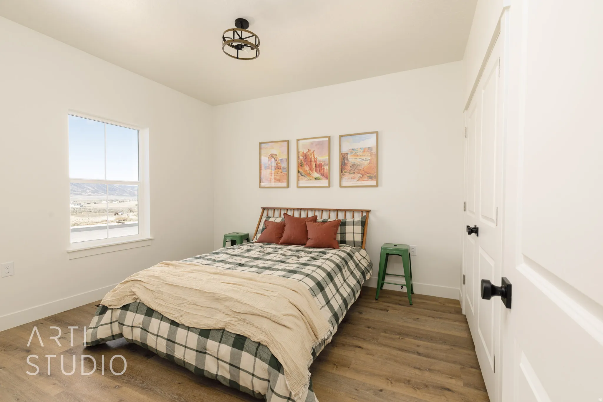 Bedroom with wood finished floors and a closet