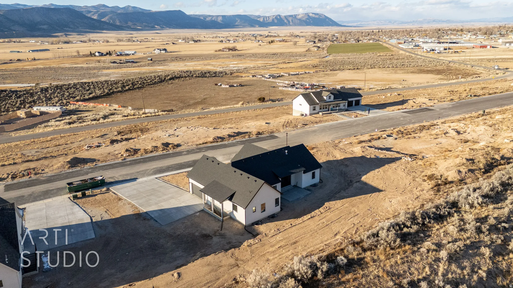 Aerial view of sparsely populated area featuring mountains and a desert landscape