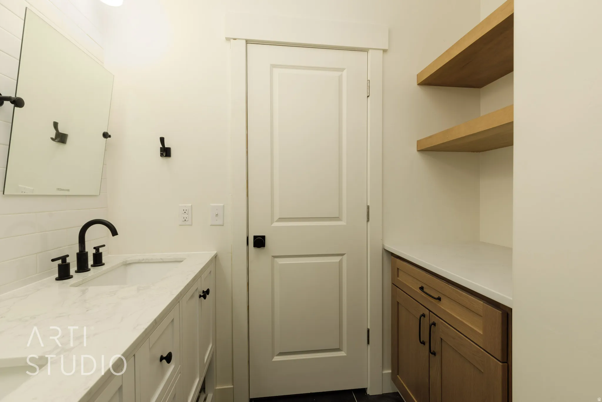 Bathroom featuring vanity and backsplash