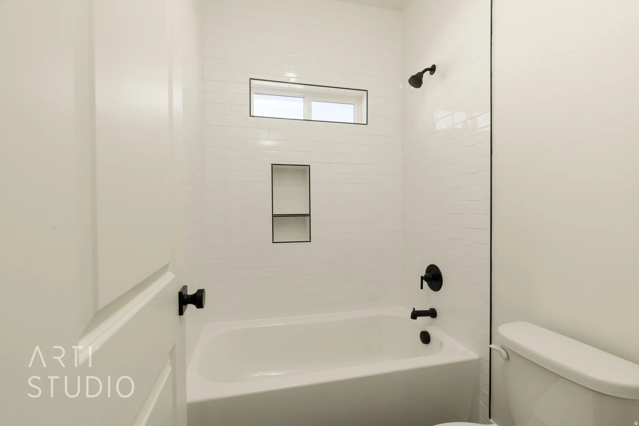 Bathroom featuring toilet and bathing tub / shower combination