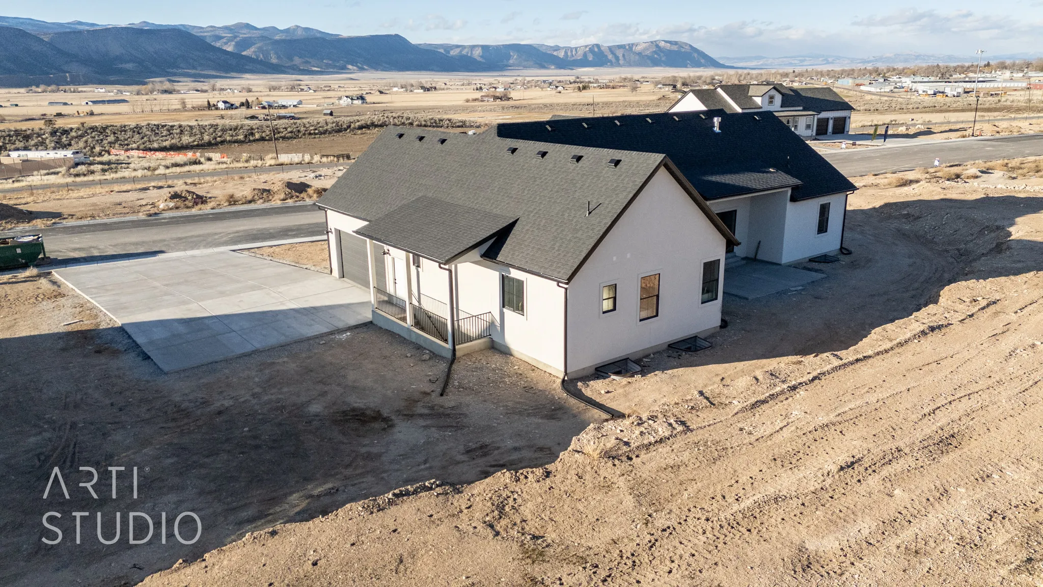 Drone / aerial view of a mountain backdrop and a desert landscape