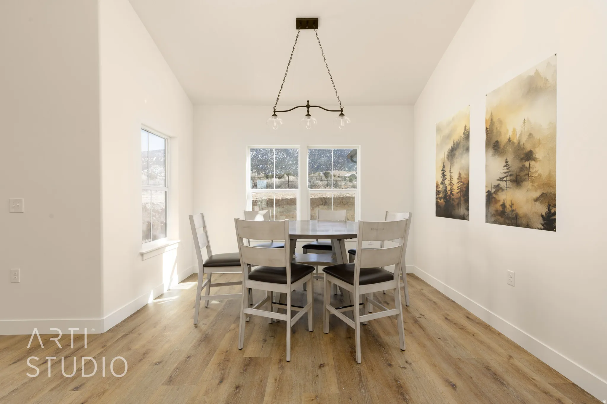 Dining room with light wood-style flooring and lofted ceiling
