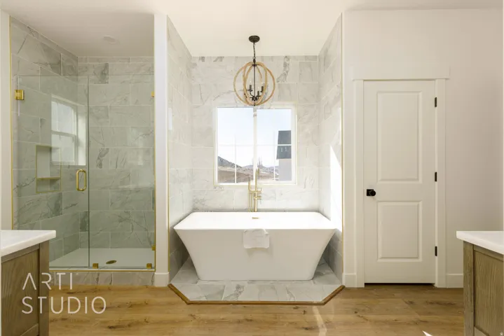 Full bathroom with vanity, a soaking tub, a stall shower, tile walls, and light wood-style flooring