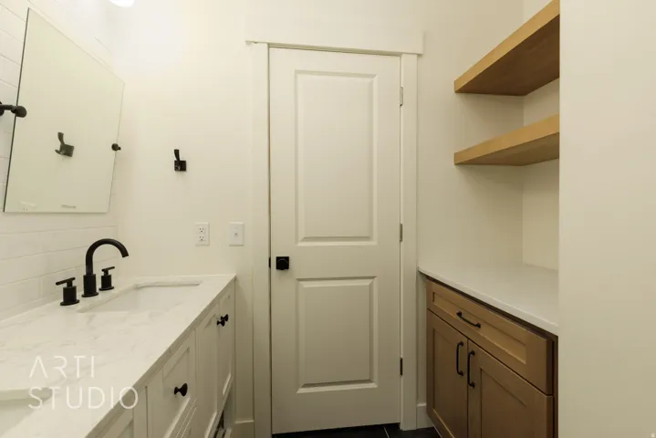 Bathroom featuring vanity and backsplash