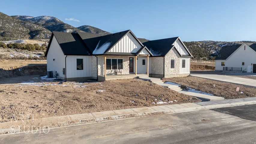 Modern inspired farmhouse featuring covered porch, a mountain view, and board and batten siding