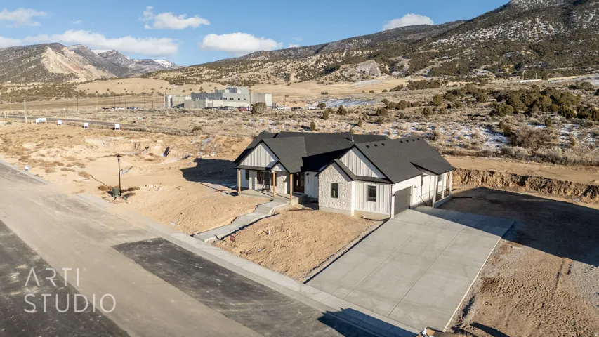 Aerial view of property and surrounding area with mountains and a desert landscape