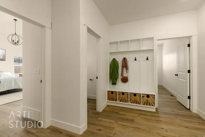 Mudroom featuring wood finished floors and a chandelier