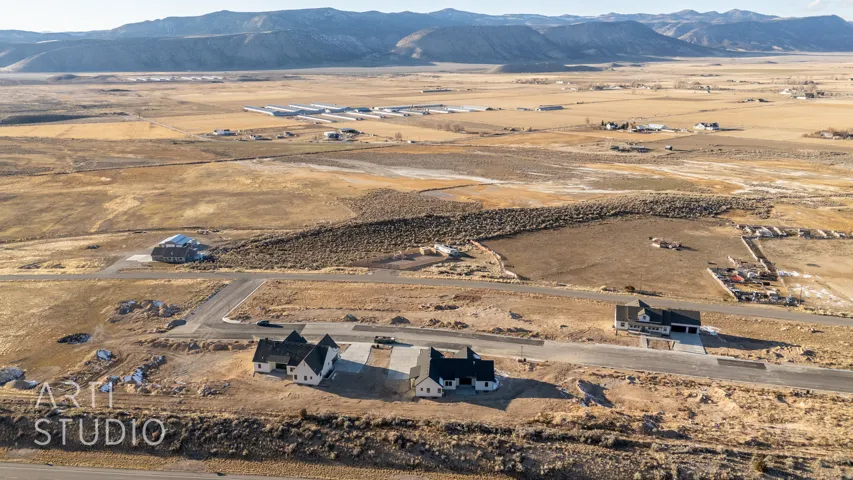 Aerial view of property's location featuring a mountainous background and rural landscape