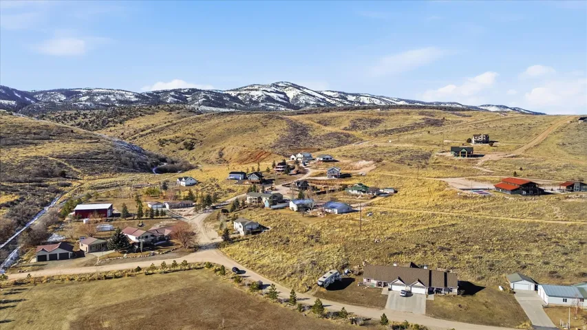 Aerial view of sparsely populated area featuring mountains and nearby suburban area