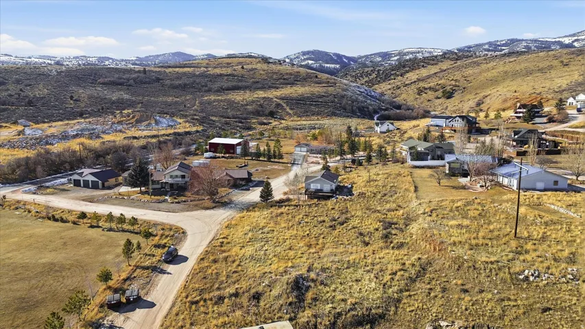Aerial overview of property's location with a mountain backdrop and nearby suburban area