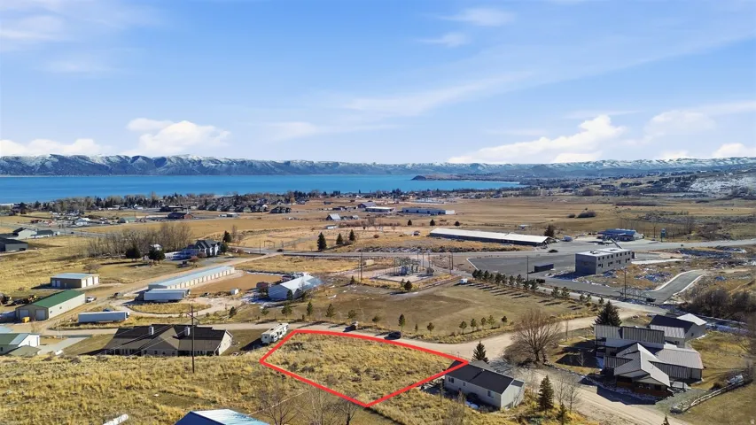 Aerial overview of property's location with property parcel outlined and a water and mountain view