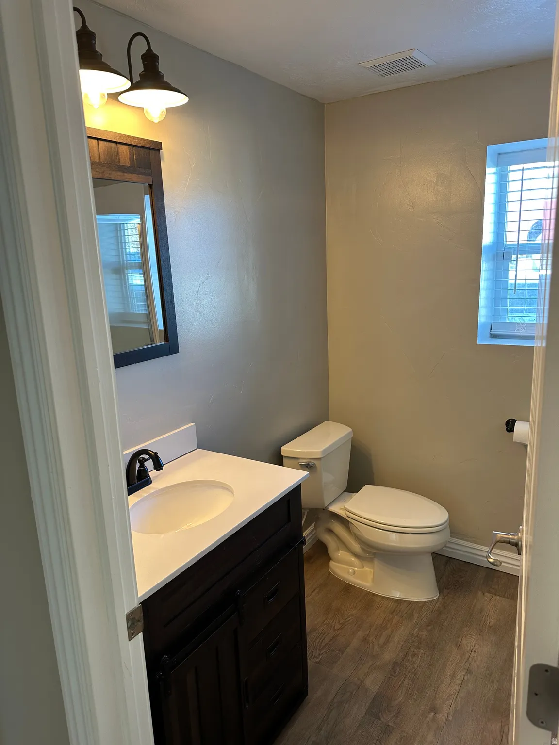 3/4 bathroom featuring vanity and dark wood-style flooring