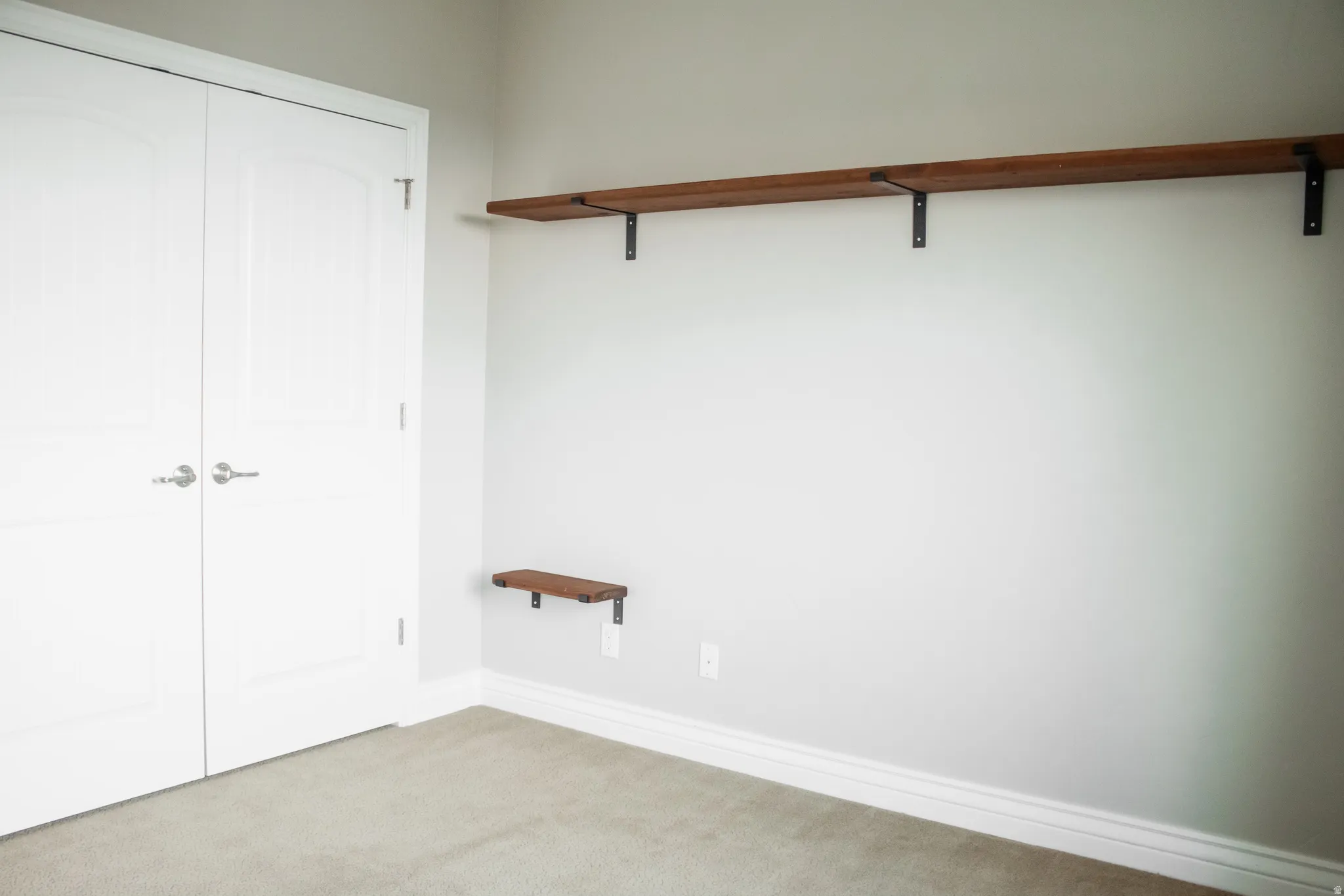 Bedroom featuring a closet, shelving, and carpet