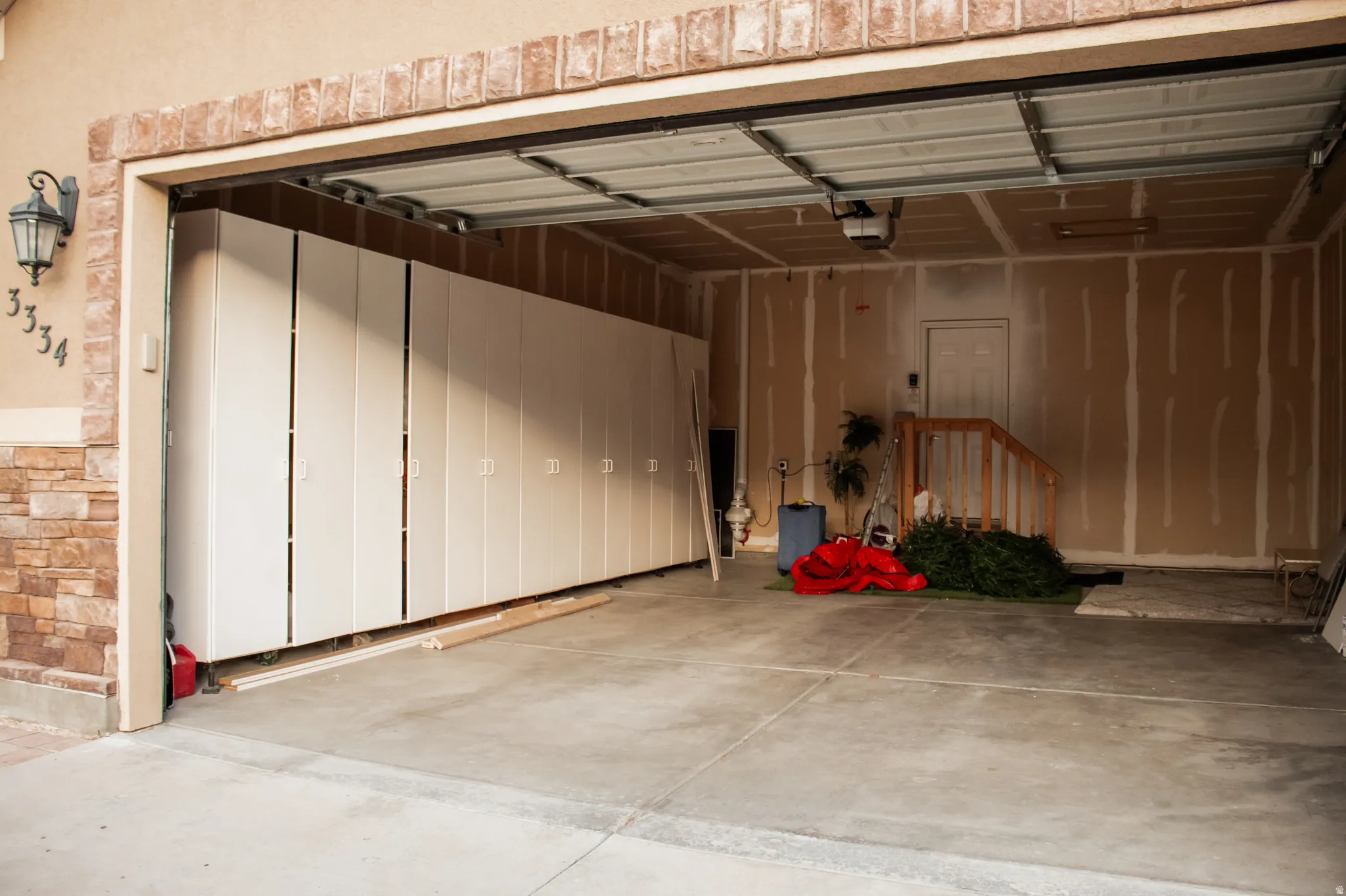 Garage with a garage door opener and massive amounts of storage space
