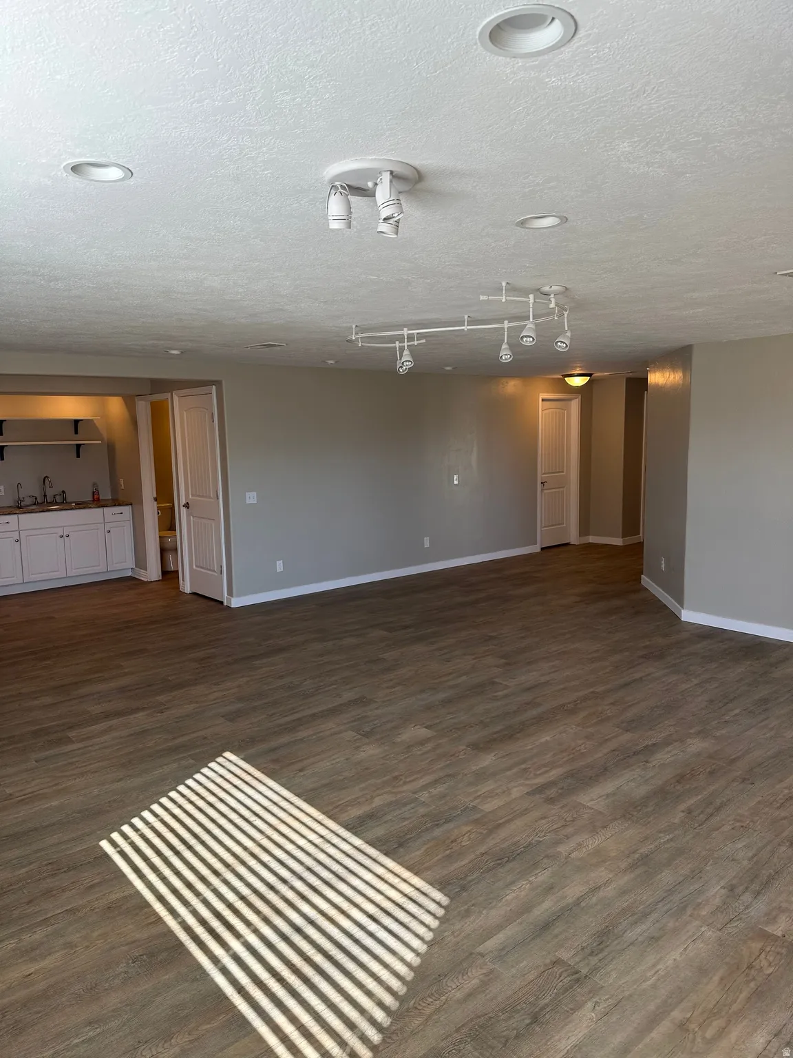 Unfurnished room featuring wood-style floors and a textured ceiling