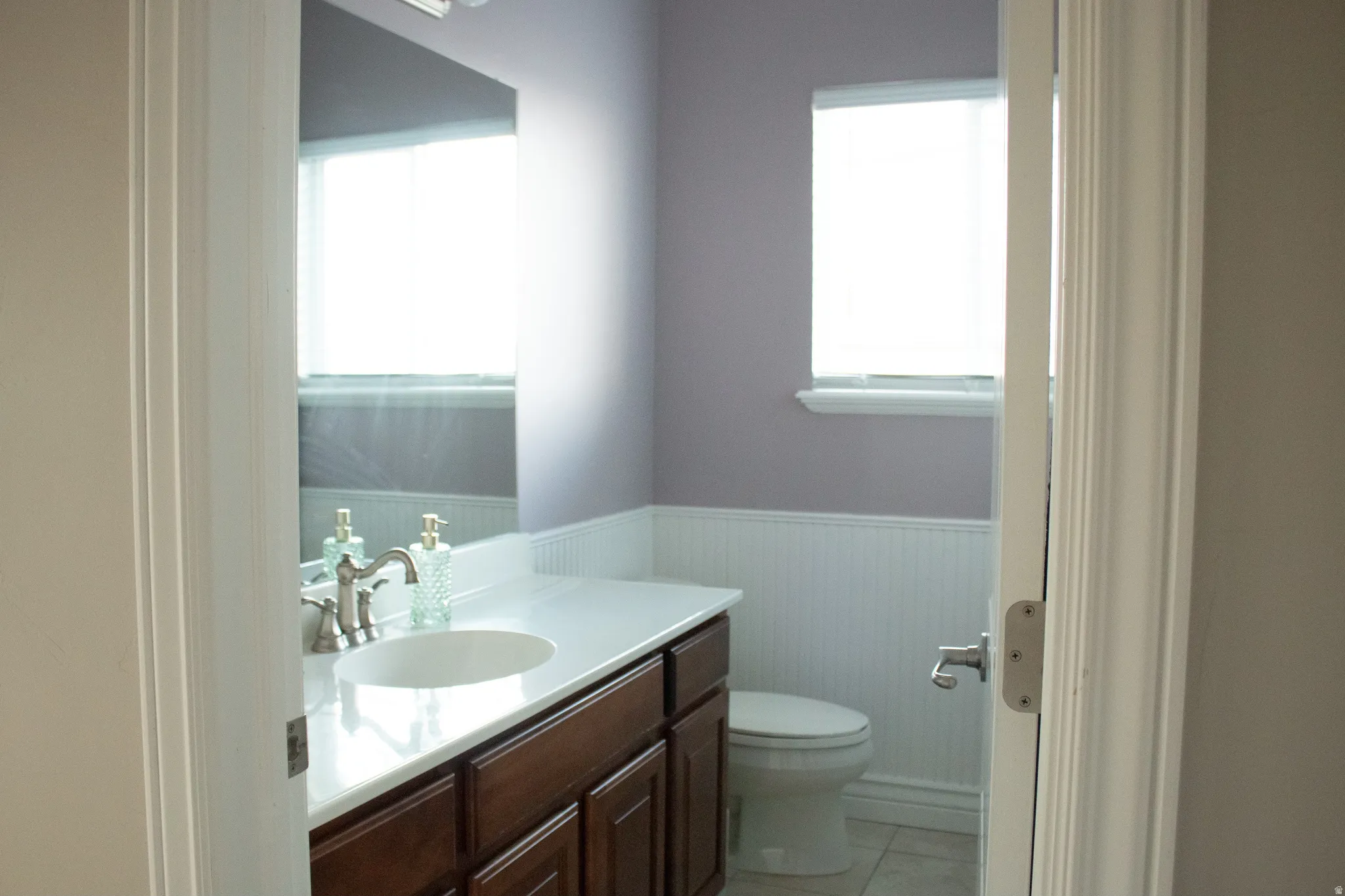 Full bathroom featuring wainscoting and vanity