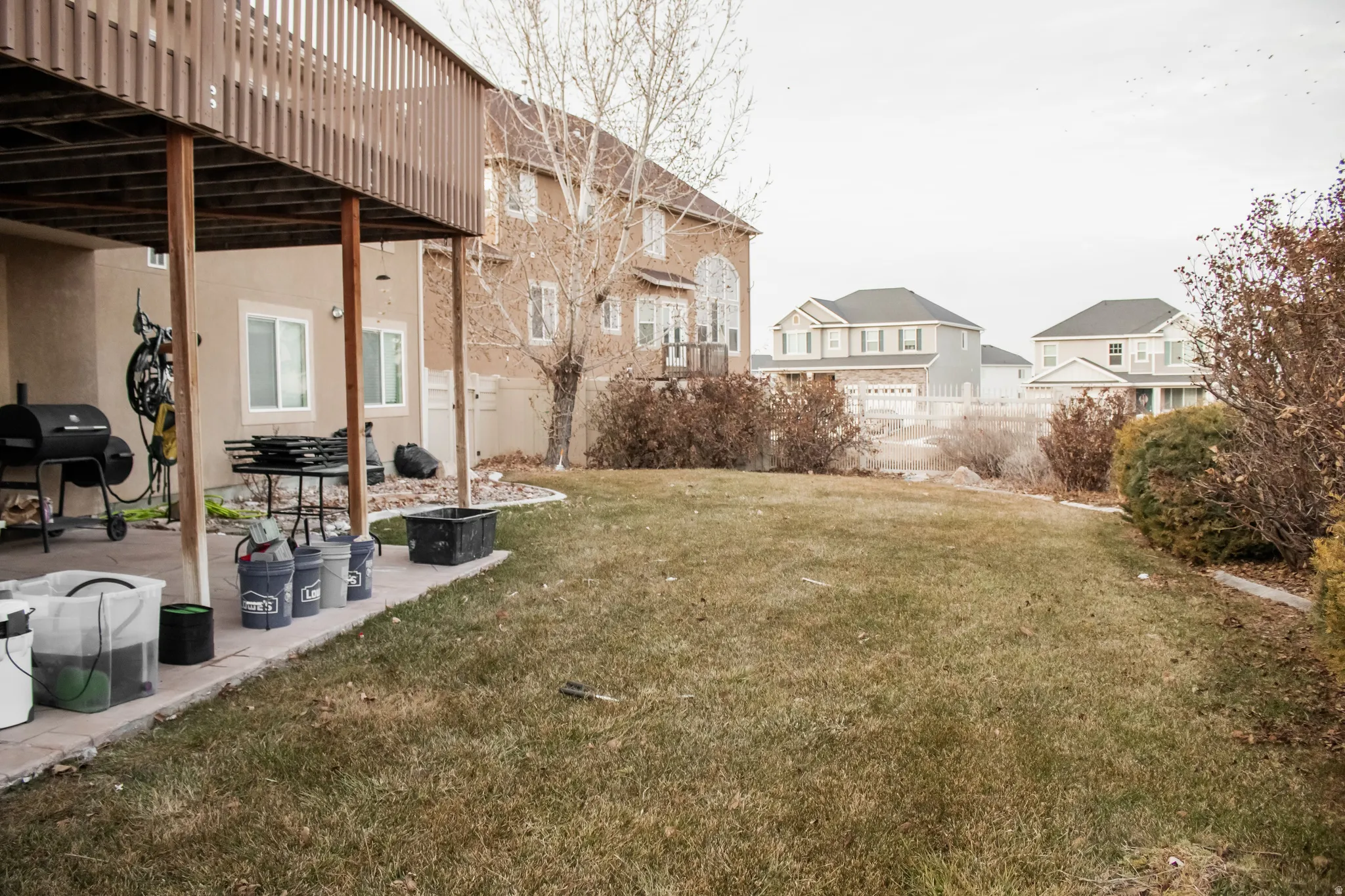 Fenced yard featuring a patio area and a residential view