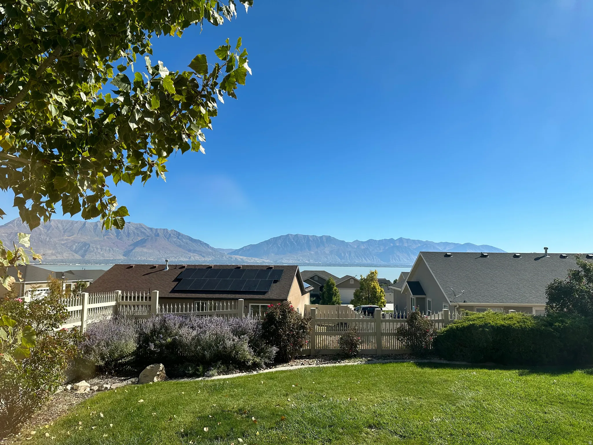 Fenced yard with a mountain/lake view
