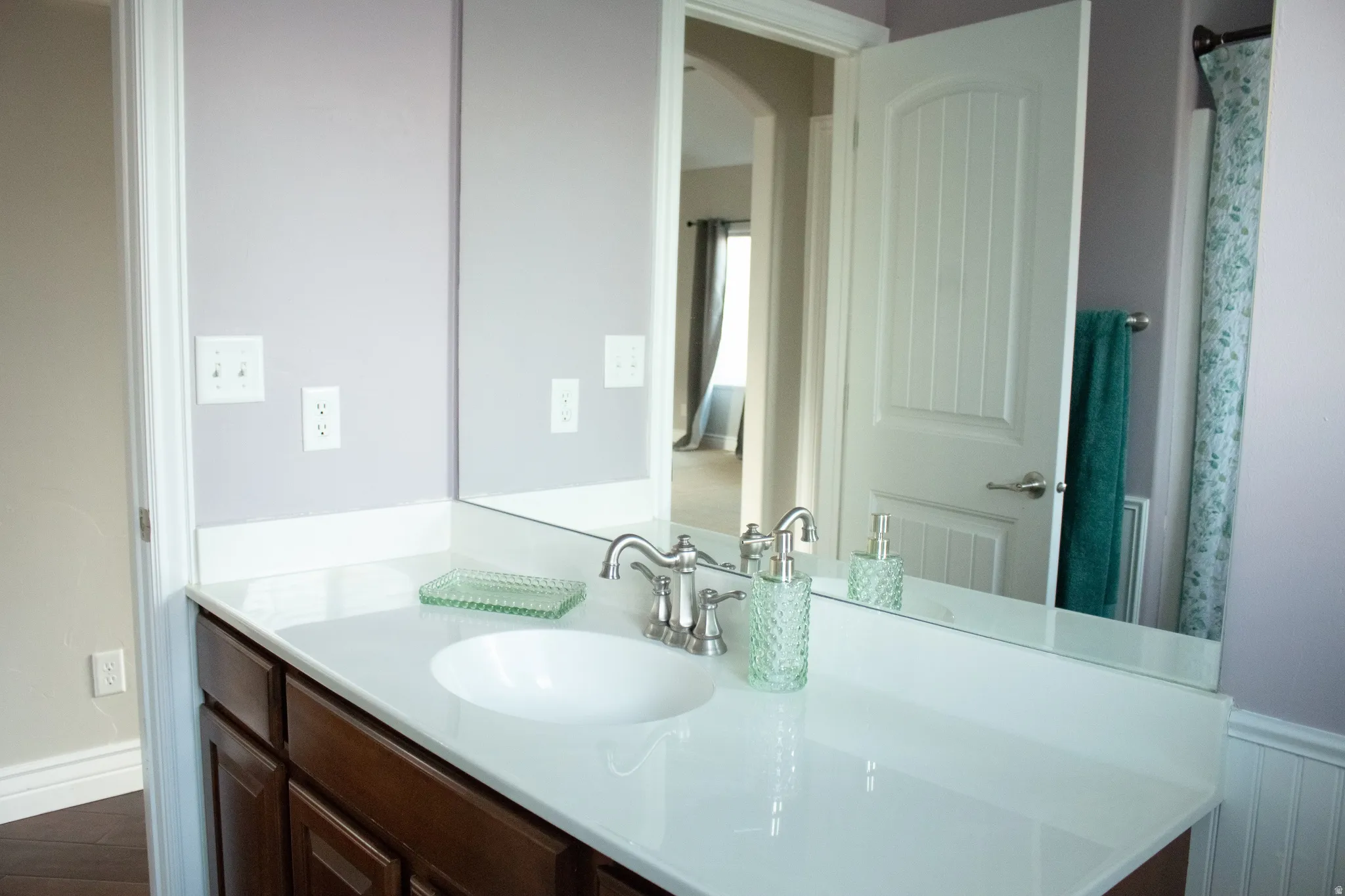 Full bathroom featuring wainscoting and vanity