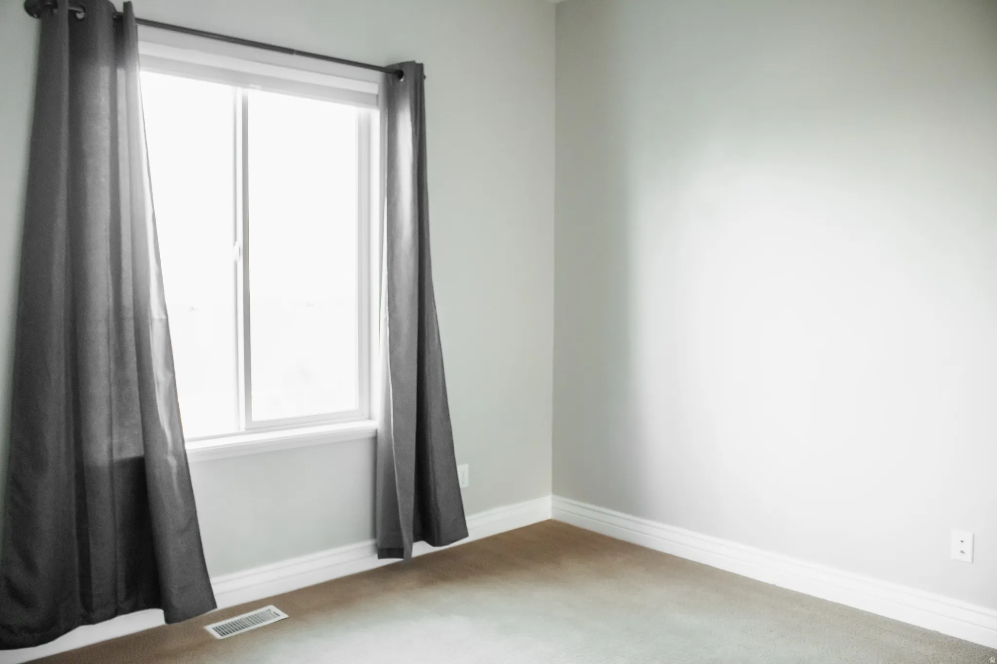 Carpeted bedroom featuring baseboards
