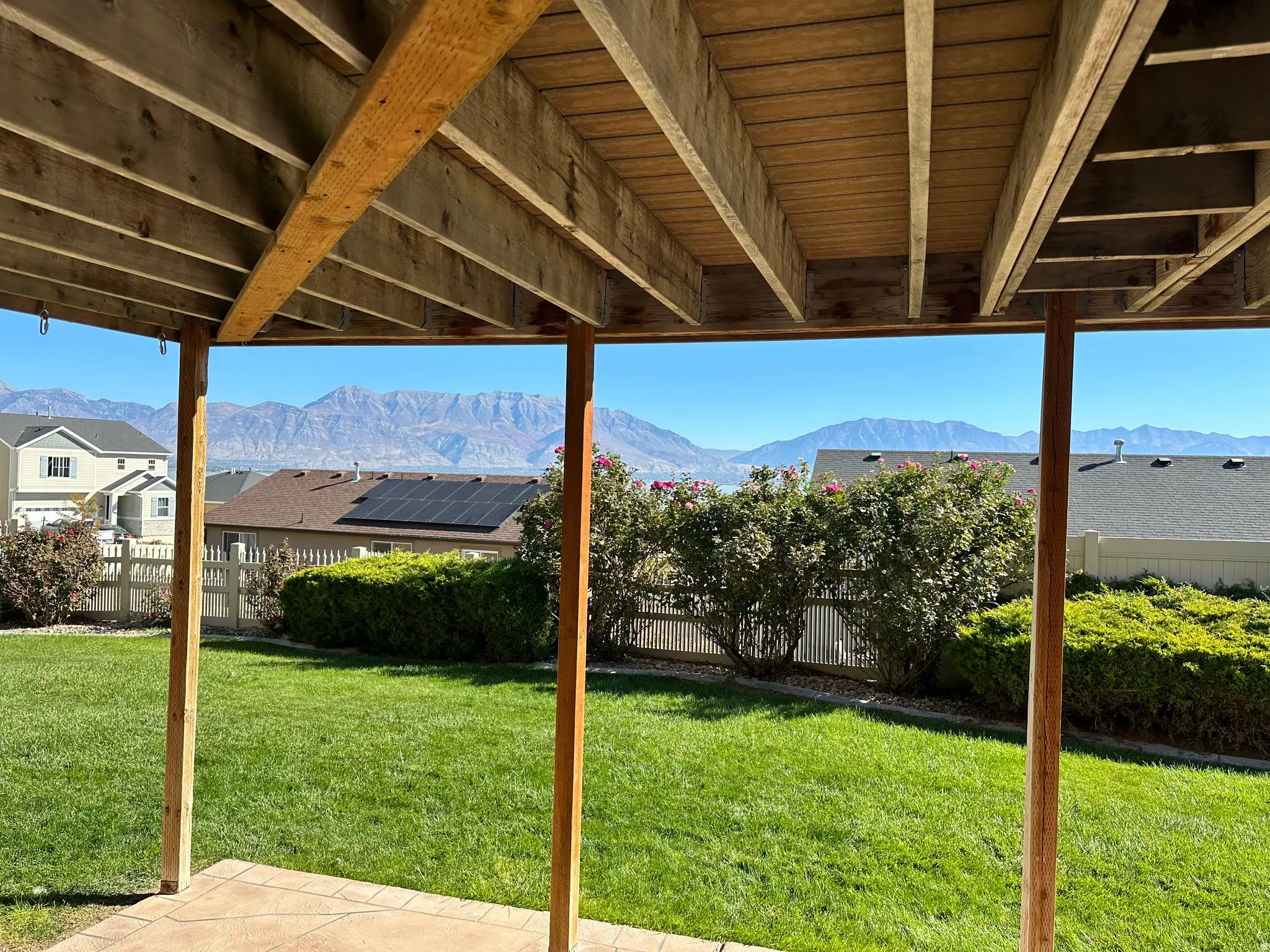 Fenced backyard featuring a mountain view and a patio