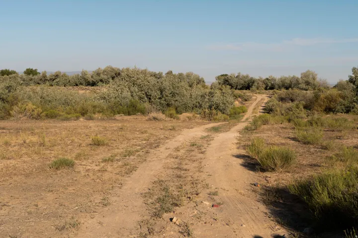 View of dirt / gravel road featuring a view of countryside