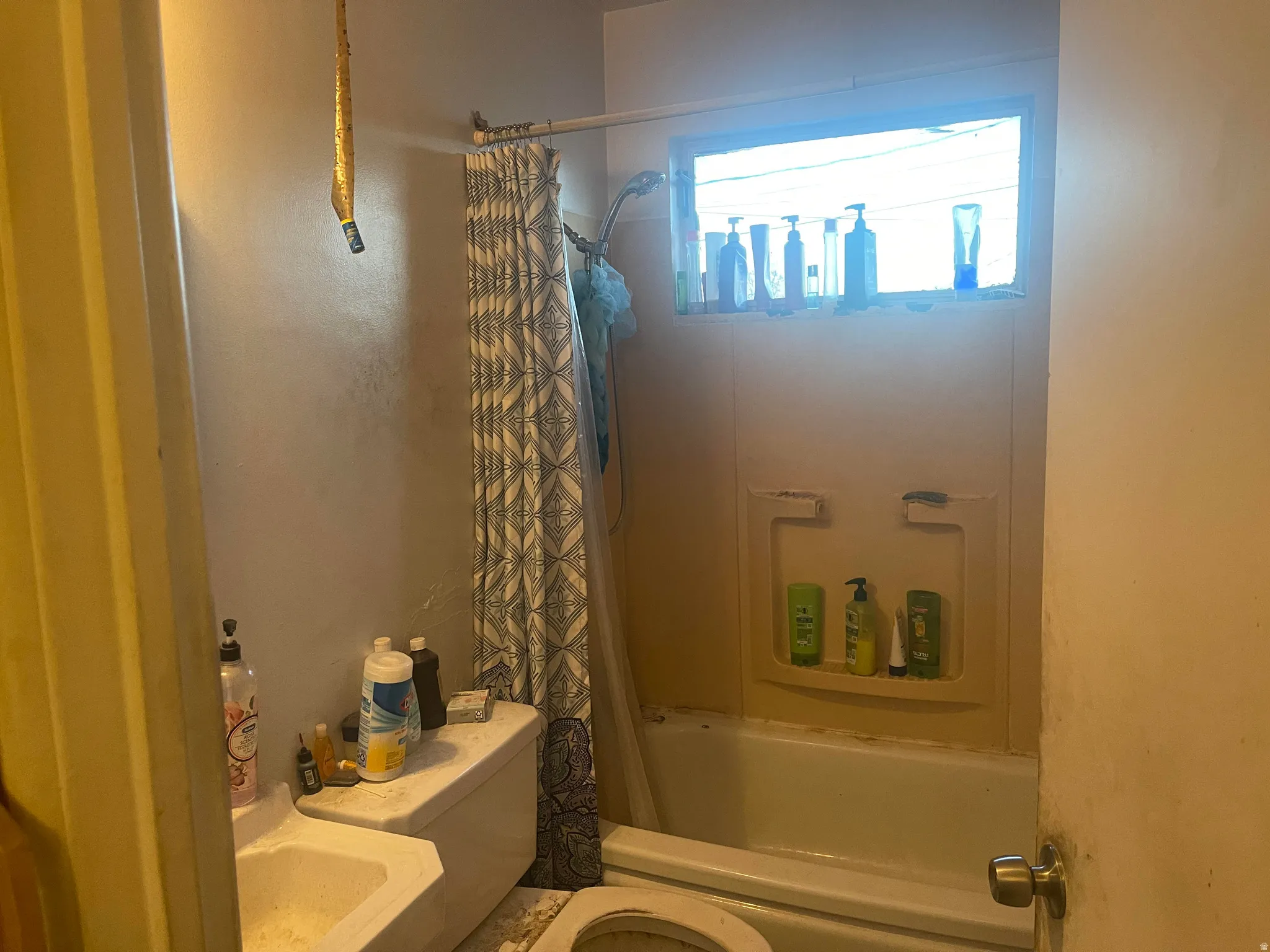 Full bathroom with toilet and shower / bathtub combination with curtain